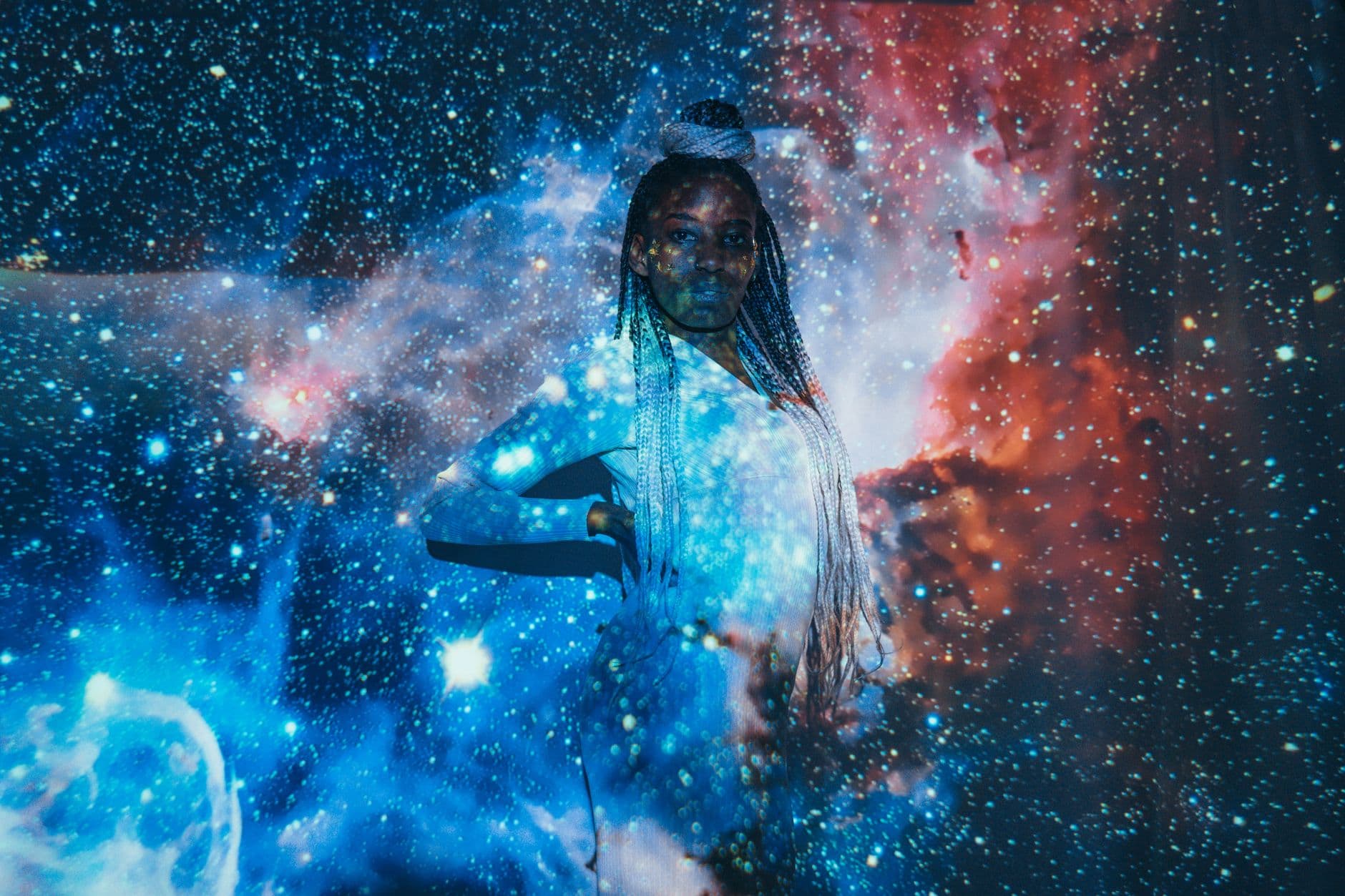 Artistic portrait of a woman with astral galaxy projection for a celestial theme.