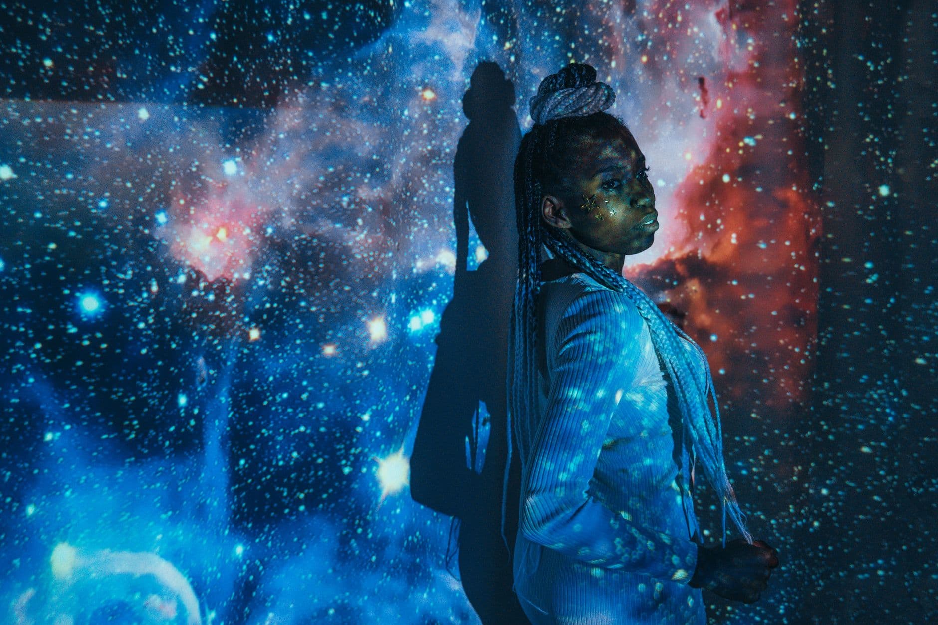 A stunning portrait of a woman amidst a cosmic backdrop, blending art and astronomy.